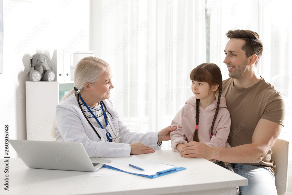 Father with child visiting doctor in hospital Father with child visiting doctor in hospital