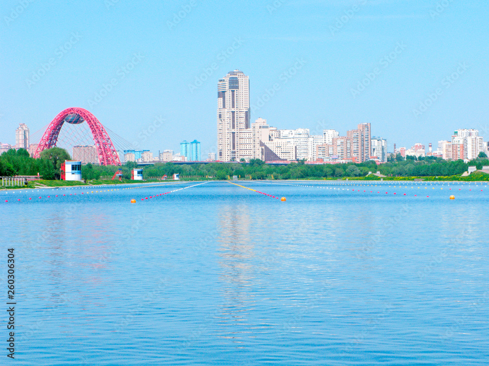 Naklejka premium Moscow, Russia, urban skyline with the Rowing channel Krylatskoe, the Picturesque Bridge and modern skyscrapers and houses. It is a sports complex for water sports, for rowing on kayaks and canoes.