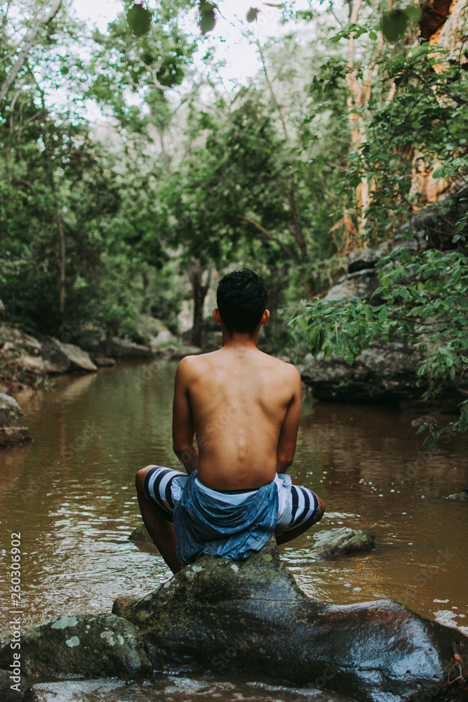 boy back to the landscape, man relaxing in the landscape, young boy exploring the landscape of rocks, river and trees boy back to the landscape, man relaxing in the landscape, young boy exploring the landscape of rocks, river and trees
