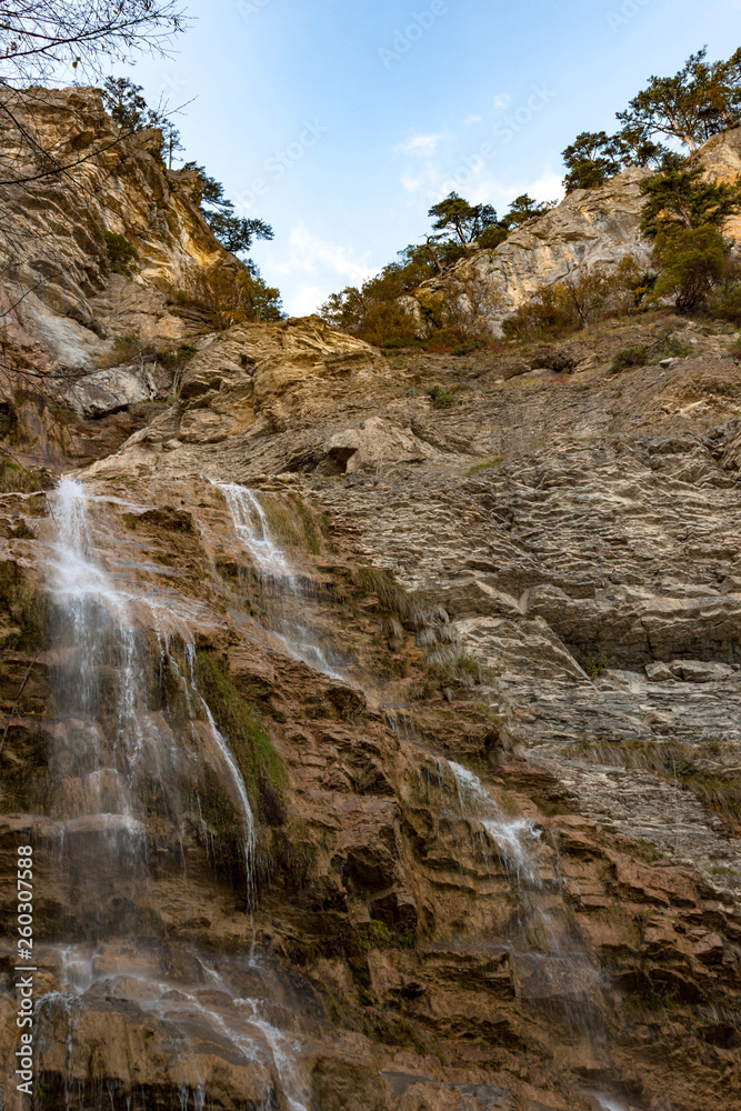 Beautiful view on Uchan-su waterfall that falls from the high rock mountain Ah-Petri in Crimea, Russia.