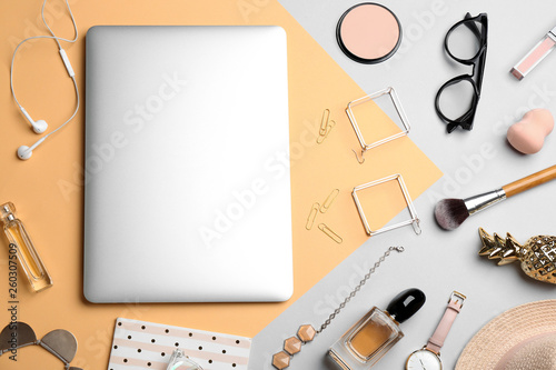 Flat lay composition with different cosmetic products and laptop on color background. Beauty blogger