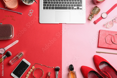 Flat lay composition with different cosmetic products, laptop, shoes and space for text on color background. Beauty blogger