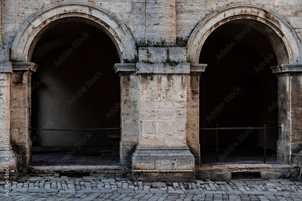 Double arch building facade on a medieval entrance in Italy
