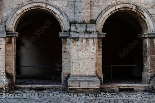 Double arch building facade on a medieval entrance in Italy