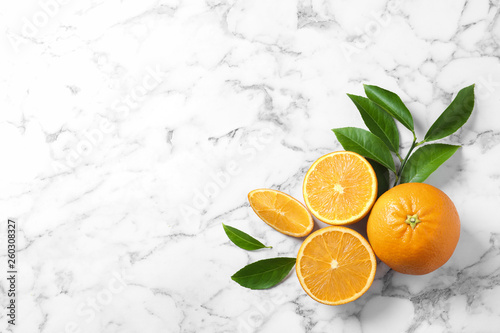 Flat lay composition with ripe oranges and space for text on marble background