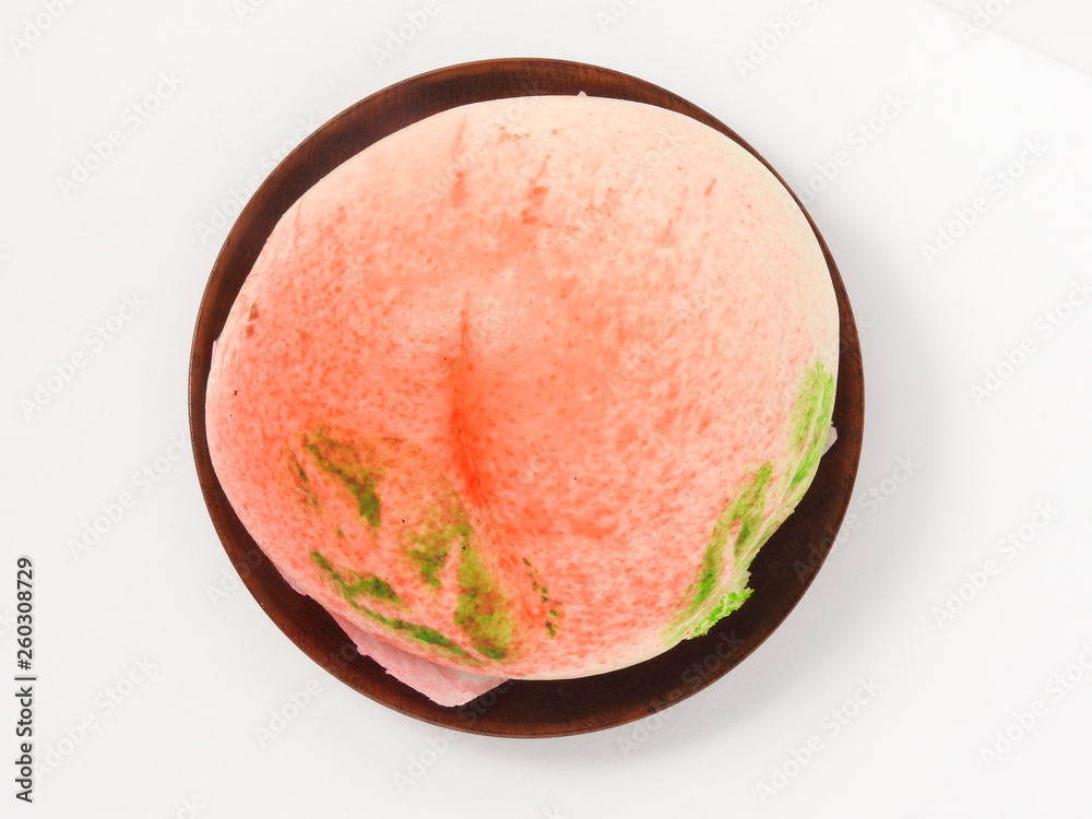 Top view of longevity peach on wooden plate isolated on white background. Chinese specialty pastry. Top view of longevity peach on wooden plate isolated on white background. Chinese specialty pastry.