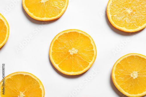 Composition with orange slices on white background, top view