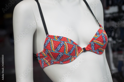 closeup of colorful bikini on mannequin in fashion store showroom for women