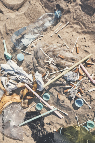 Top view of garbage on a beach, color toning applied, selective focus.