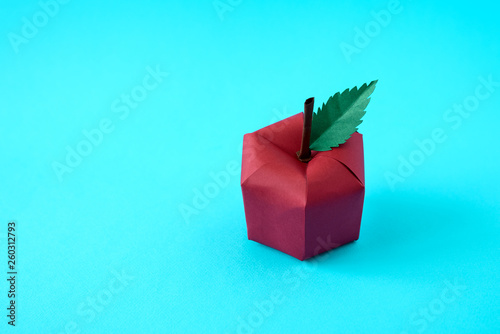 Apple made from paper on blue background. Fresh fruits. Minimal, creative, vegan, healthy or food art concept. Copy space.