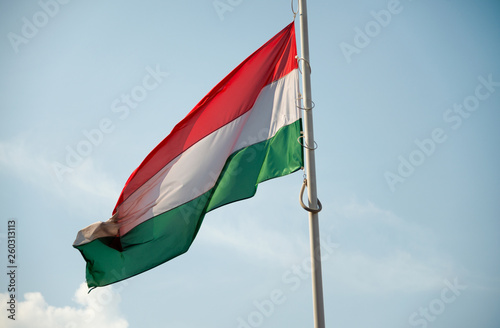 Hungarian flag waving against a blue sky