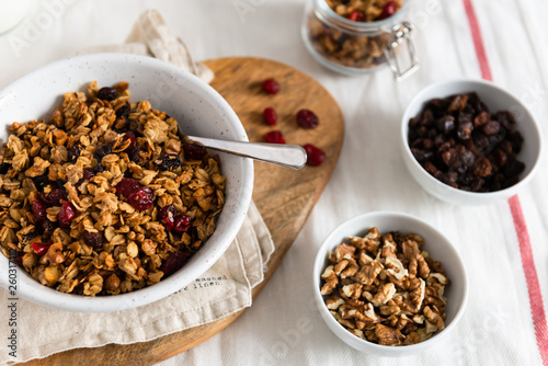 muesli with berries and nuts in bowls on white background. the concept of a healthy breakfast. Close up