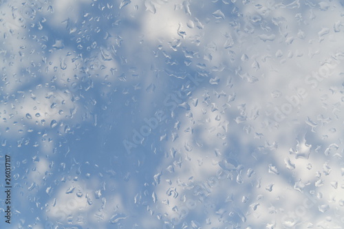 water drops on the glass against the background of clouds