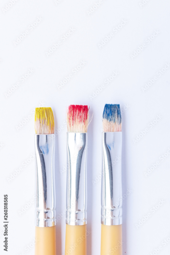 Three primary colors on white background.Red, blue and yellow color brushes.