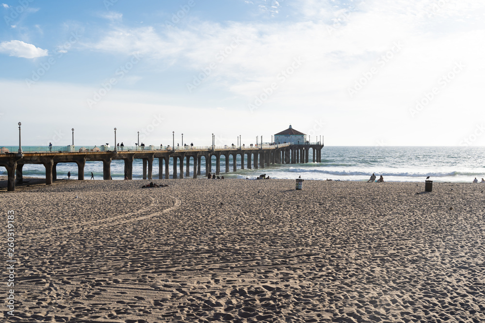 View of the Manhattan Beach pier and beach, during the late afternoon sunshine in Southern California