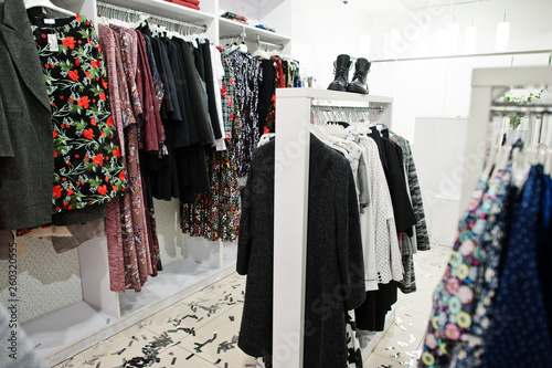 Принти на полотні Female colorful clothing set of on the racks with shoes in clothing store brand new modern boutique
