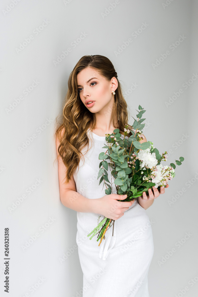 beautiful girl holding bouquet of flowers on grey beautiful girl holding bouquet of flowers on grey