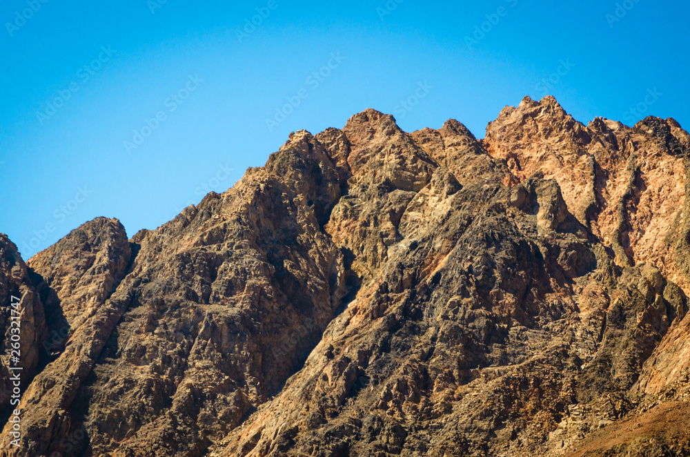 peaks of high rocky mountains against a blue sky in Egypt peaks of high rocky mountains against a blue sky in Egypt