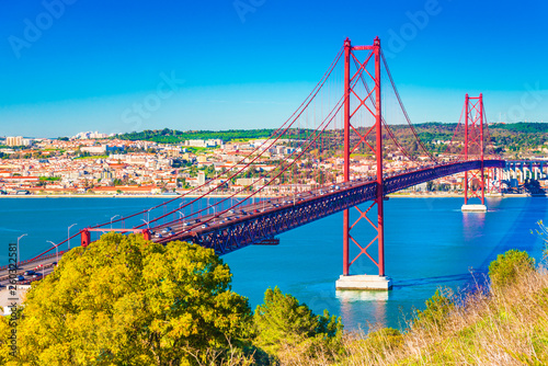 The 25th April Bridge (Ponte 25 de Abril) in Lisbon, Portugal. View from Almada photo