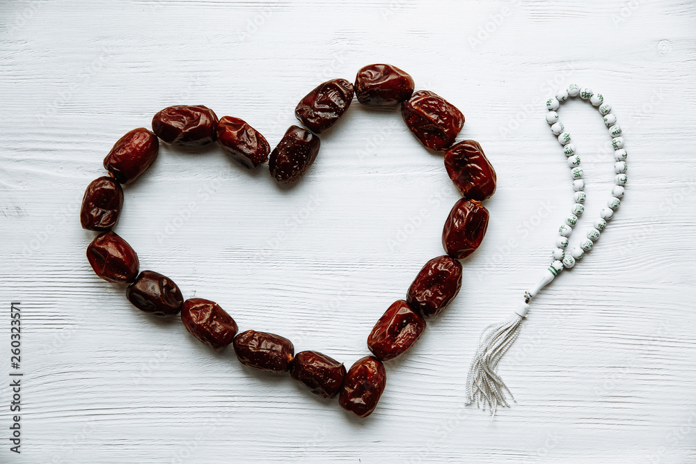 heart shaped by dates and white rosary for Ramadan and Friday message concept. heart shaped by dates and white rosary for Ramadan and Friday message concept.