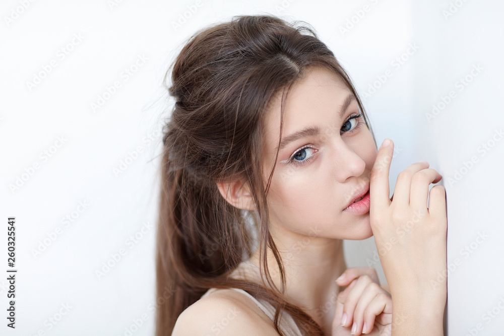 Beautiful girl, isolated on a light - grey background, emotions, cosmetics Beautiful girl, isolated on a light - grey background, emotions, cosmetics