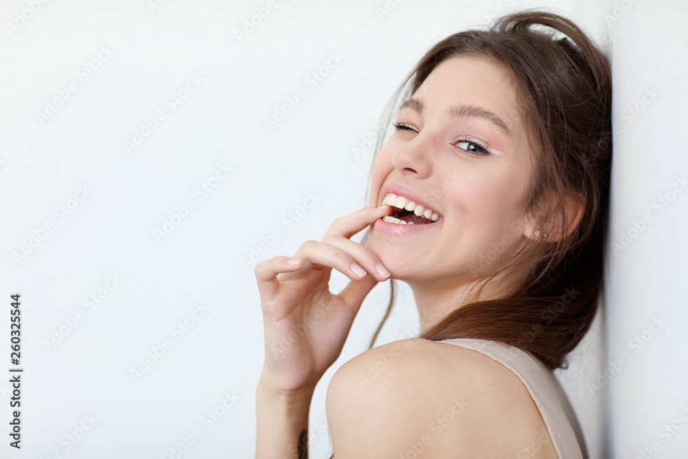 Beautiful girl, isolated on a light - grey background, emotions, cosmetics Beautiful girl, isolated on a light - grey background, emotions, cosmetics