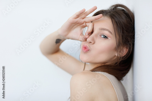 Beautiful  girl  isolated on a light - grey  background  emotions  cosmetics
