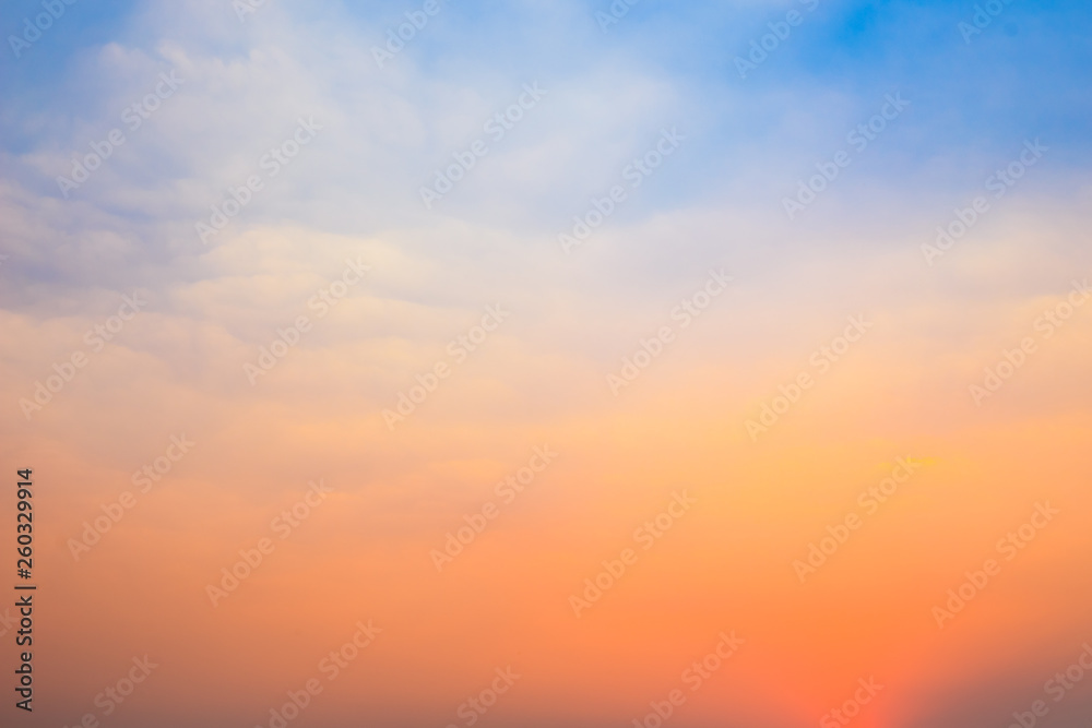 Beautiful natural background of twilight blue and orange sky with cloud in morning and evening time before sunrise or after sunset.