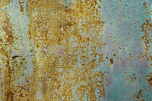 Texture of rusty metal, painted white which becames orange from rust. Horizontal texture of cracks and peels paint on rusty steel photo