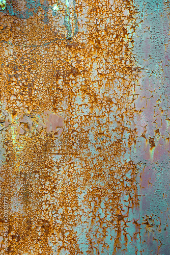 Texture of rusty metal, painted white which becames orange from rust. Vertical texture of cracks and peels paint on rusty steel