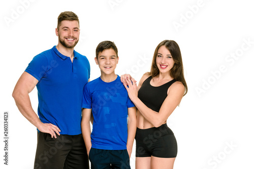 Portrait of dad, mother and son in sportswear posing on white background