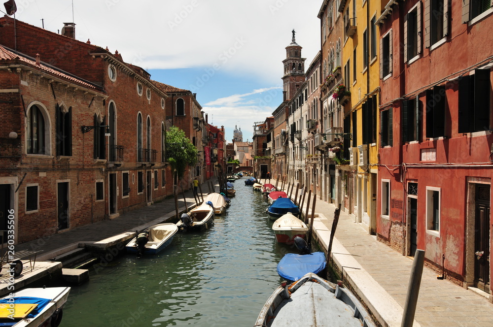 picturesque canal in Venice with colorful houses and boats