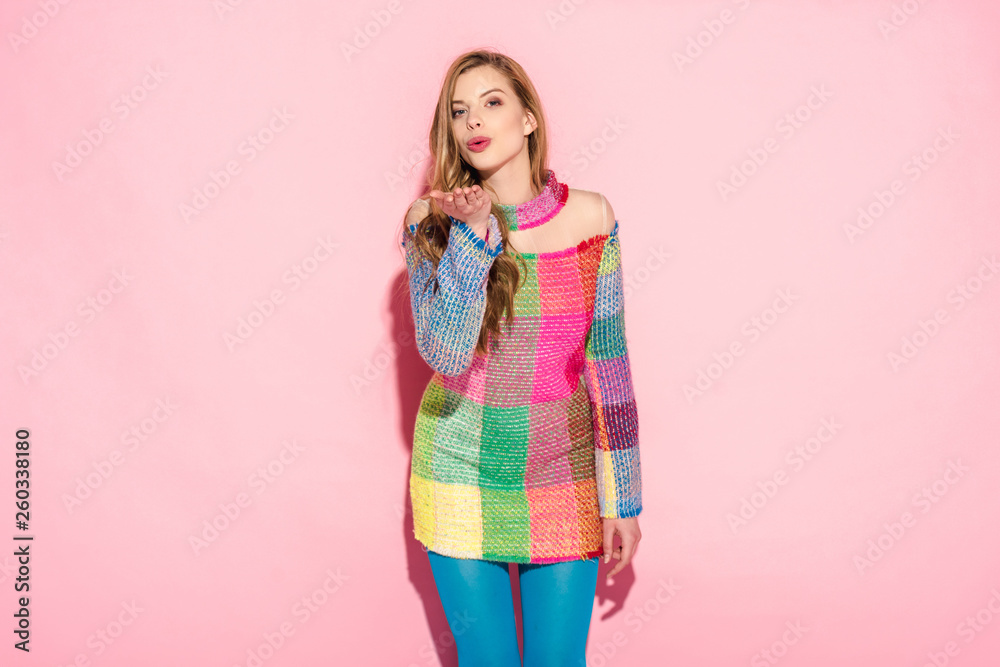 attractive girl in plaid dress sending air kiss on pink attractive girl in plaid dress sending air kiss on pink