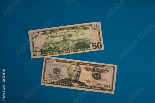 Large Fat Money Roll Isolated on a blue Background.