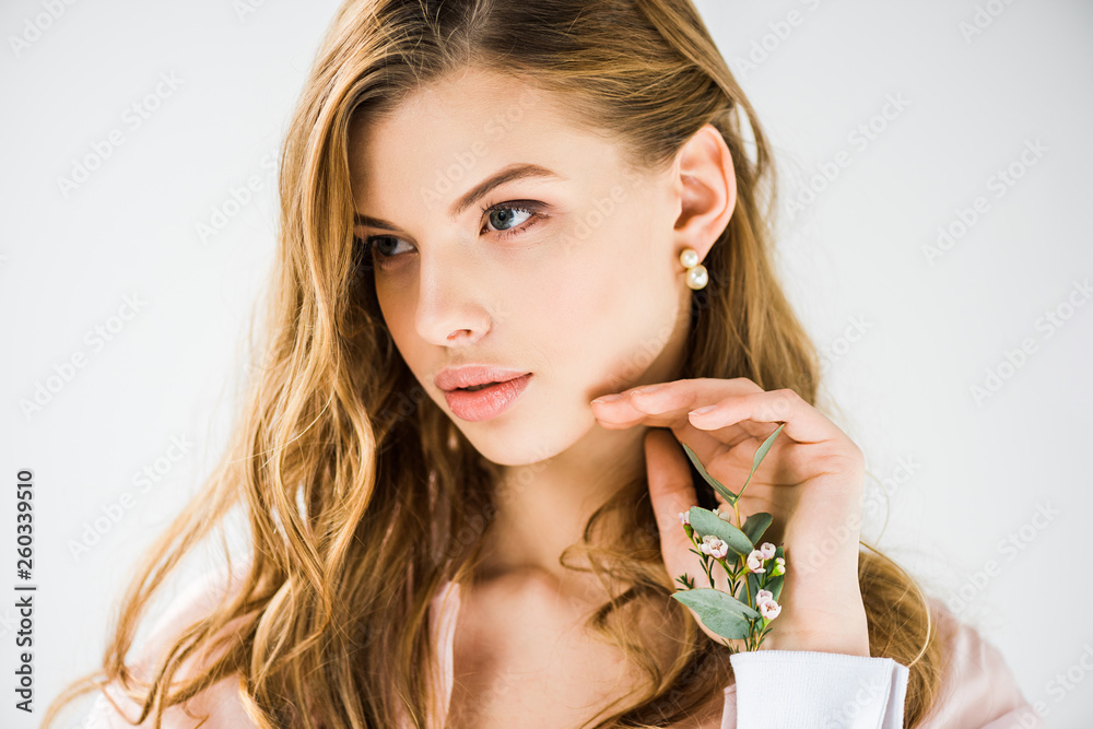 attractive woman with eucalyptus leaves and chamelaucium flowers in hand on white attractive woman with eucalyptus leaves and chamelaucium flowers in hand on white