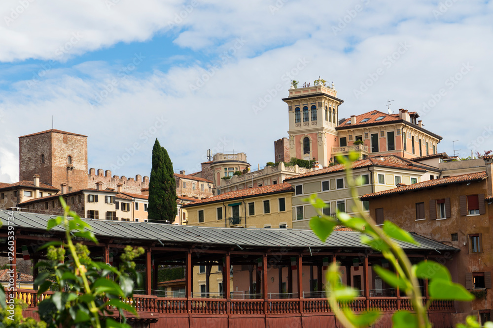 colorful houses  along river Brenta in Bassano del Grappa, Italy. With old wooden bridge