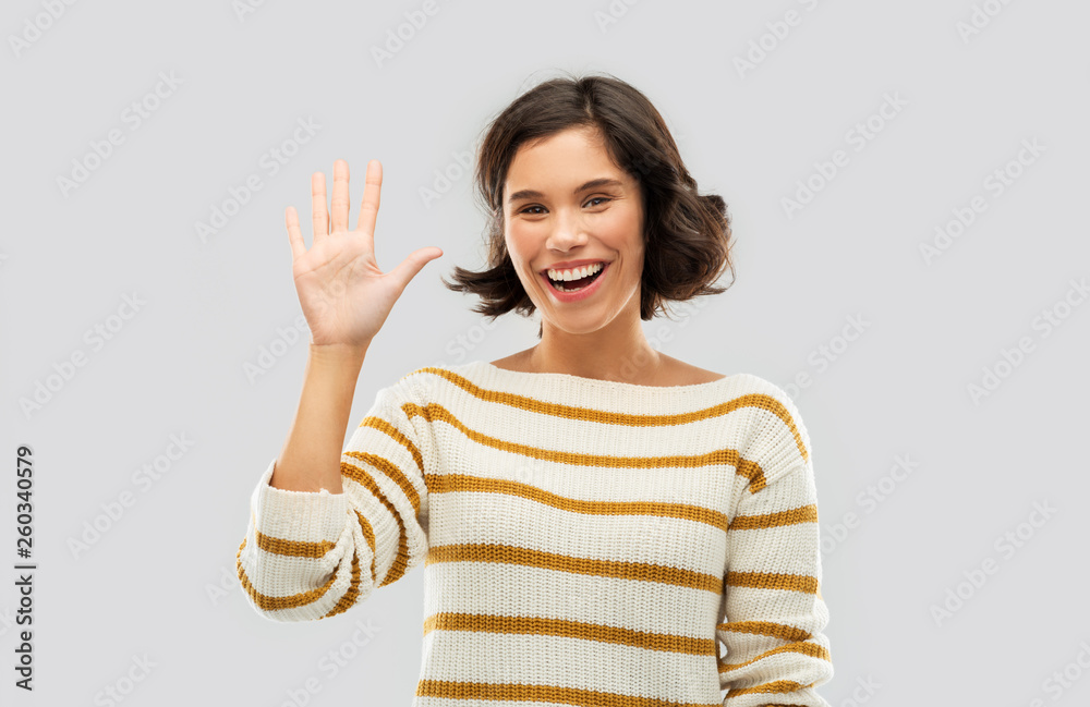 counting and people concept - happy smiling young woman in striped pullover showing five fingers of one hand over grey background counting and people concept - happy smiling young woman in striped pullover showing five fingers of one hand over grey background