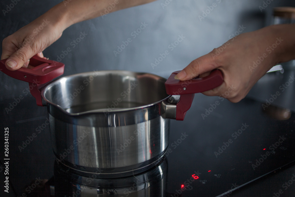 water in the pan is on the induction hob. Cooking at home water in the pan is on the induction hob. Cooking at home