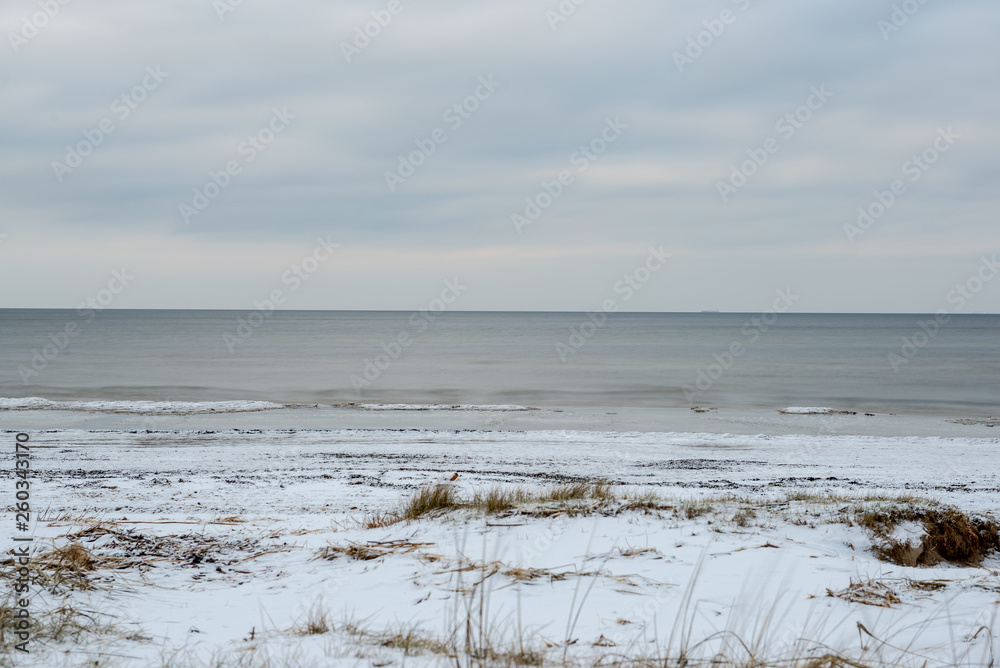 empty sea beach with ice leftovers and no snow empty sea beach with ice leftovers and no snow
