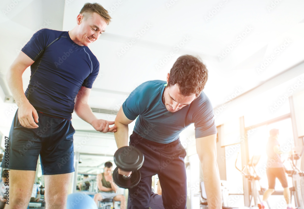 Obraz premium personal training workout coach man body build in gym.