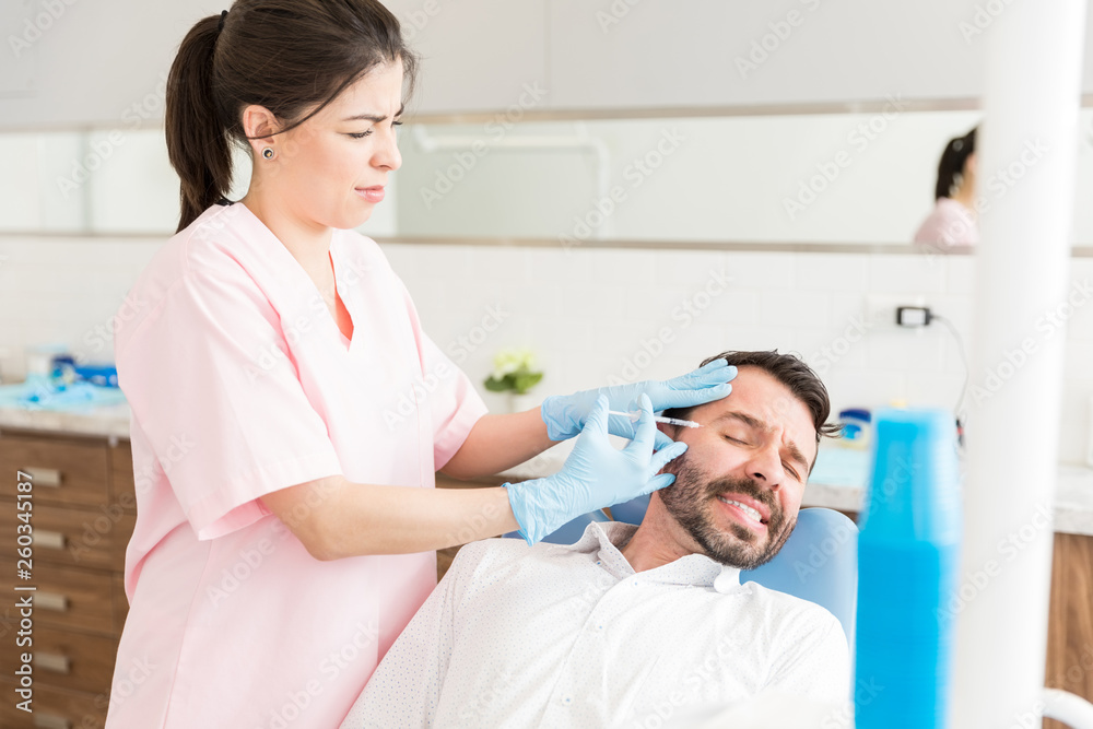 Man With Fear Of Needles Taking Neurotoxin Injection Man With Fear Of Needles Taking Neurotoxin Injection