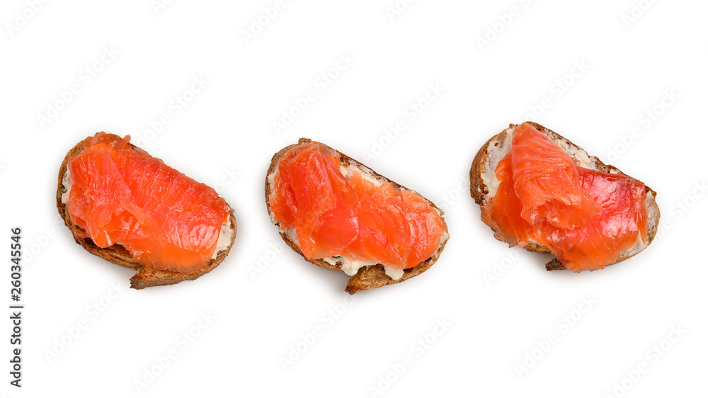 Salmon on a bread with cream isolated on white. Salmon on a bread with cream isolated on white.