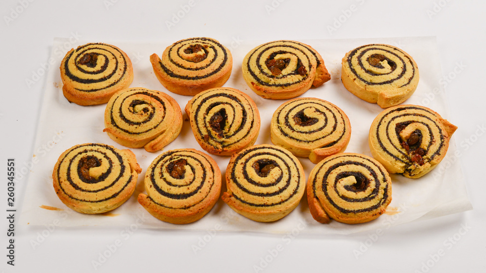 Fototapeta premium Baked cookies with raisins and poppy seeds isolated on white background.