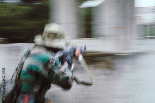 Blurry on motion Special forces soldier holding rifle aim and run