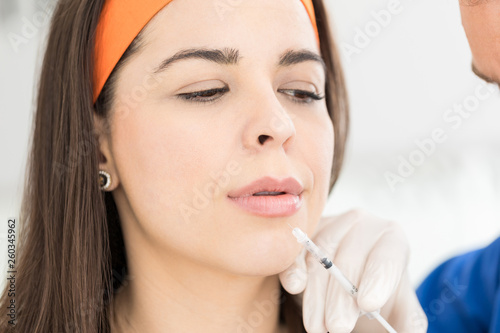 Woman Increases Her Lips Using The Syringe