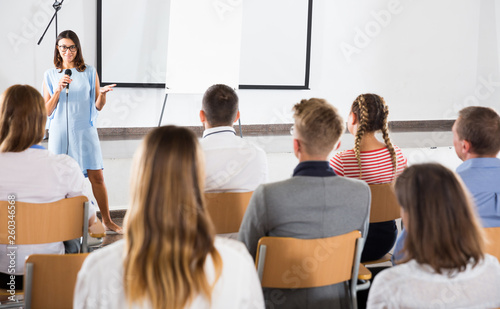 Female coach giving presentation for audience