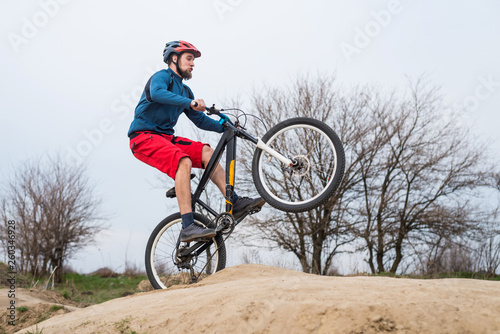 Man on a mountain bike performs a dirty jump. Active lifestyle.