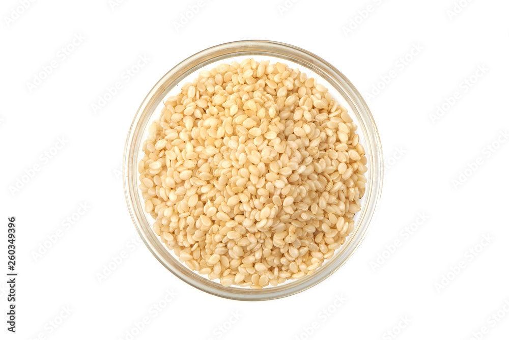 Sesame seeds in bowl, close-up, isolated on white background. Top view Sesame seeds in bowl, close-up, isolated on white background. Top view