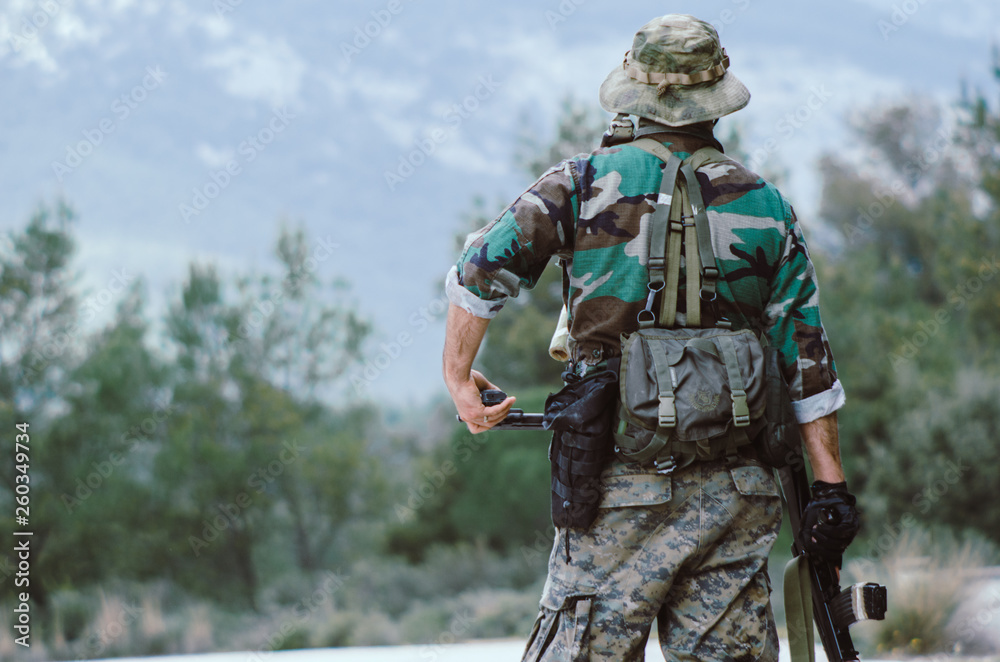 soldier hold on rifle standing at ease forest background soldier hold on rifle standing at ease forest background