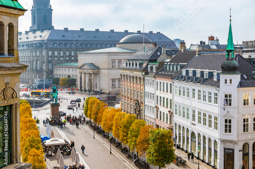 Copenhagen in the fall, people are walking around the square near the stork fountain, taking selfies sitting in restaurant, panoramic view of the city photo